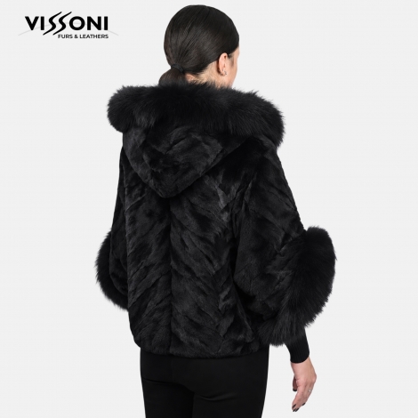 Women&prime;s coat made of natural laser-sheared fox fur, featuring a hood and voluminous cuffs.