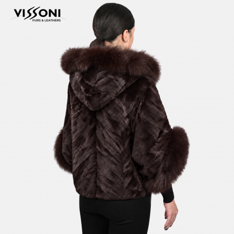 Women′s coat made of natural laser-sheared fox fur, featuring a hood and voluminous cuffs.